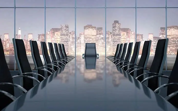 Empty corporate boardroom overlooking a city skyline